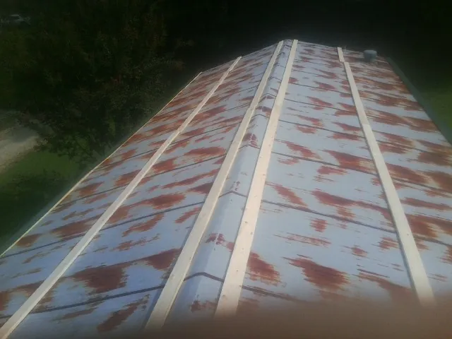 Rusted metal roof panels with new wood purlins before replacement — Storm Damage Roof Repair in Maineville by Roofing Brothers